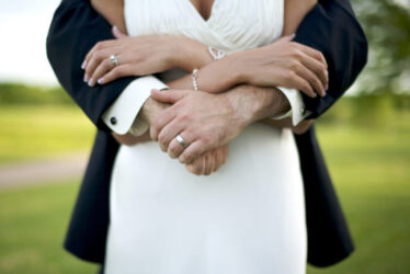 A man and woman embracing one another at their wedding