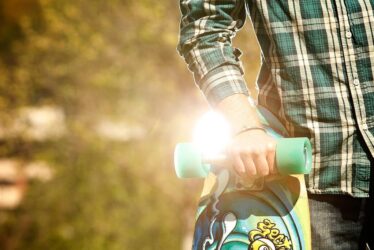 A man holding a skateboard