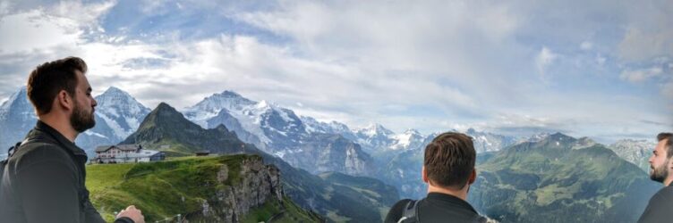 3 men looking at mountains during the day